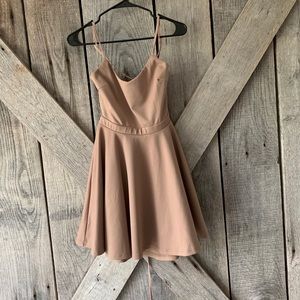Nude color skater dress with lace up back